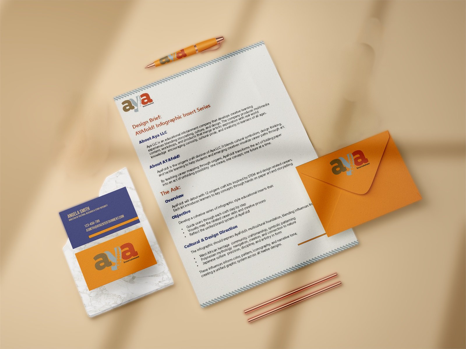 Aya parent brand stationery: letterhead, orange envelope, folder, and business cards on a warm beige background
